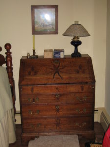 Irish oak secretarie w dropwell, inlaid pin wheels & tulip-3 drawer $7,500-$3,750